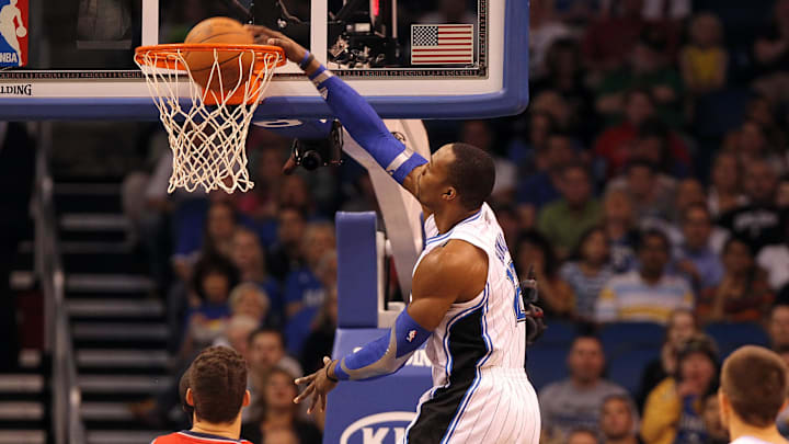 March 16, 2012; Orlando FL, USA; Orlando Magic center Dwight Howard (12) drunks against the New Jersey Nets during the first half at Amway Center. Mandatory Credit: Kim Klement-Imagn Images