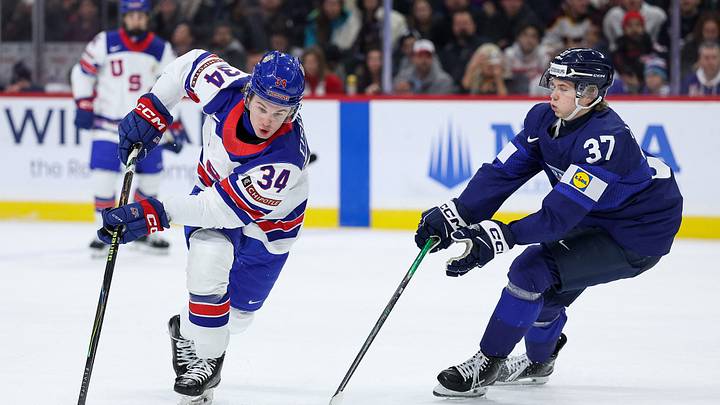 Jan 2, 2026; St. Paul, Minnesota, UNITED STATES; United States forward Cole Eiserman (34) and Finland forward Matias Vanhanen (37) compete for the puck during the first period in the quarterfinals of the 2026 IIHF World Junior Championship at Grand Casino Arena. Mandatory Credit: Matt Krohn-Imagn Images