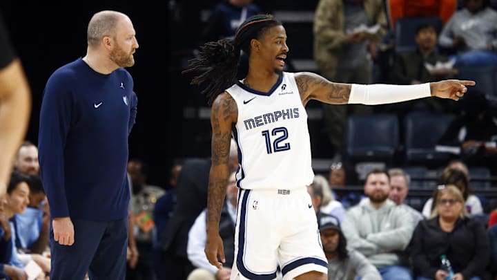 Memphis Grizzlies head coach Taylor Jenkins talks with guard Ja Morant (12) during the second half against the Portland Trail Blazers at FedExForum. 