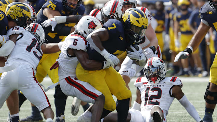 Sep 14, 2024; Ann Arbor, Michigan, USA; Michigan Wolverines running back Donovan Edwards (7) is tackled by Arkansas State Red Wolves safety Dontay Joyner (6) during the first half at Michigan Stadium. Mandatory Credit: Rick Osentoski-Imagn Images Sep 14, 2024; Ann Arbor, Michigan, USA; Michigan Wolverines running back Donovan Edwards (7) is tackled by Arkansas State Red Wolves safety Dontay Joyner (6) during the first half at Michigan Stadium. Mandatory Credit: Rick Osentoski-Imagn Images