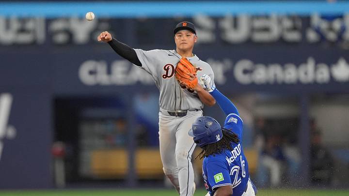 Sep 14, 2026; Toronto, Ontario, CAN;  Detroit Tigers second baseman Hao Yu Lee (50) turns a double play against Toronto Blue Jays pinch runner Charles McAdoo (26)  and  catcher Alejandro Kirk (not pictured) during the ninth inning at Rogers Centre.  Mandatory Credit: John E. Sokolowski-Imagn Images