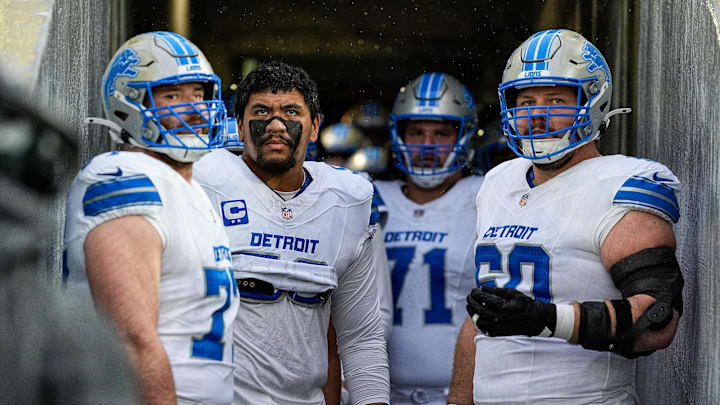From left, Detroit Lions center Frank Ragnow (77), offensive tackle Penei Sewell (58), guard Kevin Zeitler (71), and guard Graham Glasgow (60) look on from the visiting team tunnel before taking the field for the first half against Green Bay Packers at Lambeau Field in Green Bay, Wis., on Sunday, Nov. 3, 2024.