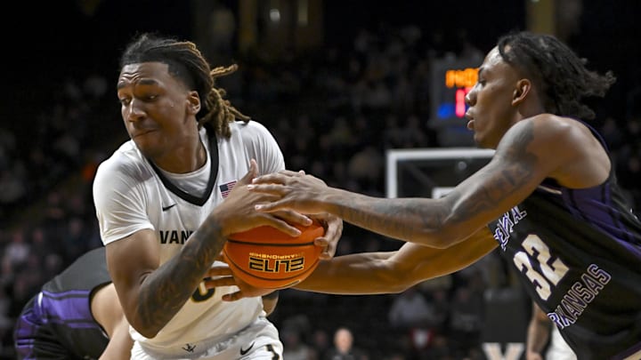 Dec 13, 2025; Nashville, Tennessee, USA;  Central Arkansas Bears guard Luke Moore (32) steals the ball from Vanderbilt Commodores guard Tyler Harris (8) during the second half at Memorial Gymnasium. Mandatory Credit: Steve Roberts-Imagn Images