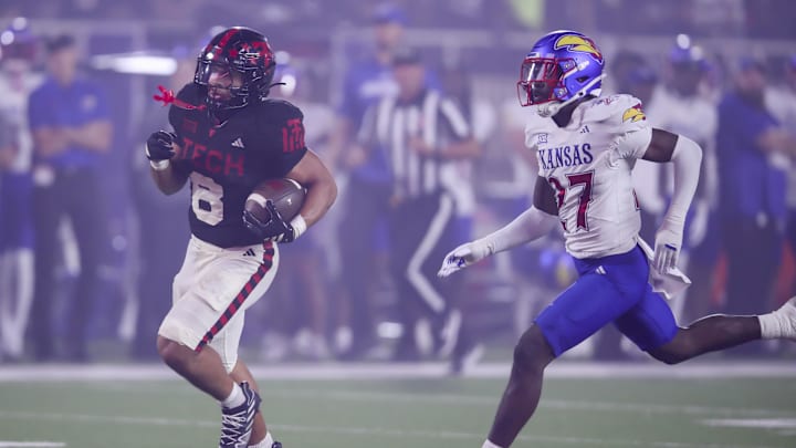 Oct 11, 2025; Lubbock, Texas, USA;  Texas Tech Red Raiders running back Cameron Dickey (8) rushes for a touchdown against Kansas Jayhawks defensive safety Taylor Davis (27) in the second half at Jones AT&T Stadium. Mandatory Credit: Michael C. Johnson-Imagn Images