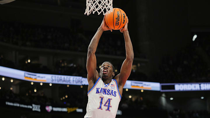 Dec 7, 2025; Kansas City, Missouri, USA; Kansas Jayhawks guard Melvin Council Jr. (14) dunks the ball during the first half against the Missouri Tigers at T-Mobile Center. Mandatory Credit: Jay Biggerstaff-Imagn Images