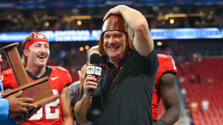 Aug 31, 2024; Atlanta, Georgia, USA; Georgia Bulldogs head coach Kirby Smart wears the old leather helmet after a victory over the Clemson Tigers at Mercedes-Benz Stadium. Mandatory Credit: Brett Davis-Imagn Images