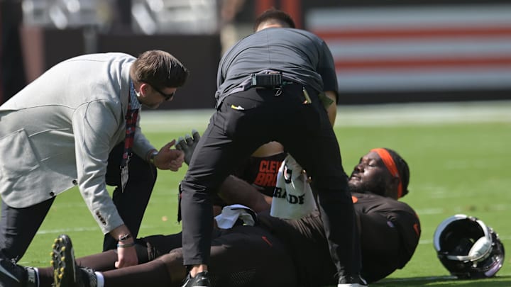 Sep 21, 2025; Cleveland, Ohio, USA; Cleveland Browns offensive tackle Dawand Jones (79) lies on the field after being injured against the Green Bay Packers during the first quarter at Huntington Bank Field. Mandatory Credit: Ken Blaze-Imagn Images