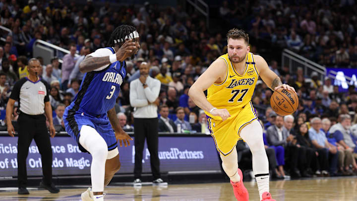 Mar 24, 2025; Orlando, Florida, USA; Los Angeles Lakers guard Luka Doncic (77) drives to the basket against the Orlando Magic in the second quarter at Kia Center. Mandatory Credit: Nathan Ray Seebeck-Imagn Images