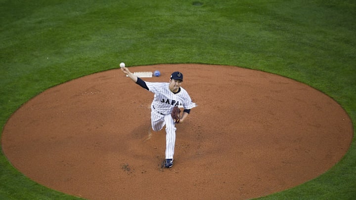 Mar 21, 2017; Los Angeles, CA, USA; Japan starting pitcher Tomoyuki Sugano (11) pitches against the United States during the first inning of the 2017 World Baseball Classic at Dodger Stadium. Mandatory Credit: Kelvin Kuo-Imagn Images