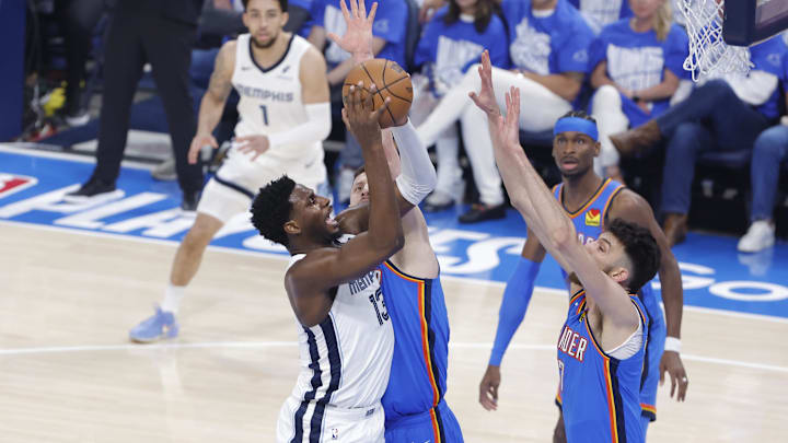 Apr 22, 2025; Oklahoma City, Oklahoma, USA; Memphis Grizzlies forward Jaren Jackson Jr. (13) shoots as Oklahoma City Thunder center Isaiah Hartenstein (55) and forward Chet Holmgren (7) defend the shot in the first quarter during game two of first round for the 2024 NBA Playoffs at Paycom Center. Mandatory Credit: Alonzo Adams-Imagn Images