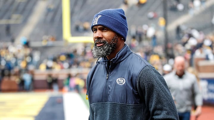 Michigan legend Charles Woodson waves at fans during warmup at the spring game at Michigan Stadium in Ann Arbor on Saturday, April 20, 2024.