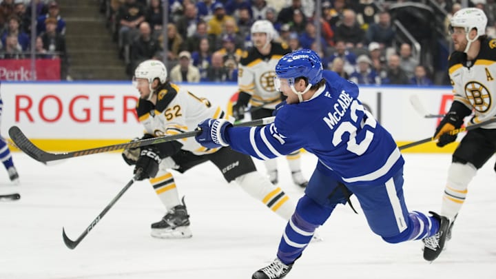 Jan 4, 2025; Toronto, Ontario, CAN; Toronto Maple Leafs defenceman Jake McCabe (22) scores on this shot against the Boston Bruins during the first period at Scotiabank Arena. Mandatory Credit: John E. Sokolowski-Imagn Images