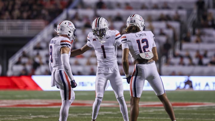 Sep 28, 2024; Salt Lake City, Utah, USA; Arizona Wildcats defensive back Gunner Maldonado (9), defensive back Tacario Davis (1) and defensive back Genesis Smith (12) celebrate a stop on fourth down against the Utah Utes during the first quarter at Rice-Eccles Stadium. Mandatory Credit: Rob Gray-Imagn Images