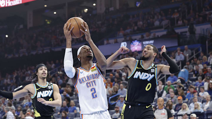 Mar 12, 2024; Oklahoma City, Oklahoma, USA; Oklahoma City Thunder guard Shai Gilgeous-Alexander (2) drives to the basket beside Indiana Pacers guard Tyrese Haliburton (0) during the first quarter at Paycom Center. Mandatory Credit: Alonzo Adams-Imagn Images