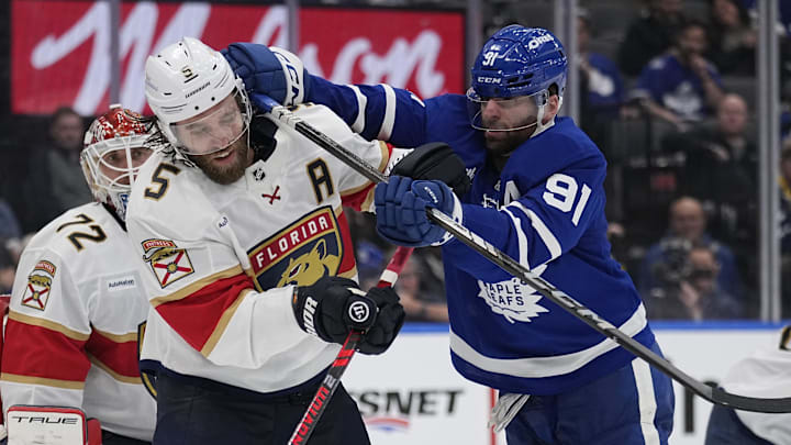 May 14, 2025; Toronto, Ontario, CAN; Toronto Maple Leafs forward John Tavares (91) checks Florida Panthers defenseman Aaron Ekblad (5) during the third period of game five of the second round of the 2025 Stanley Cup Playoffs at Scotiabank Arena. Mandatory Credit: John E. Sokolowski-Imagn Images
