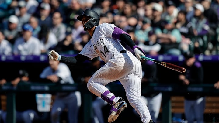 Apr 6, 2025; Denver, Colorado, USA; Colorado Rockies shortstop Ezequiel Tovar (14) watches his ball on a two RBI single in the eighth inning against the Athletics at Coors Field. Mandatory Credit: Isaiah J. Downing-Imagn Images