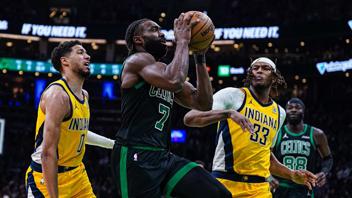 Dec 27, 2024; Boston, Massachusetts, USA; Boston Celtics guard Jaylen Brown (7) drives the ball against Indiana Pacers guard Tyrese Haliburton (0) and center Myles Turner (33) in the second quarter at TD Garden. Mandatory Credit: David Butler II-Imagn Images