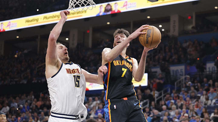 Mar 9, 2025; Oklahoma City, Oklahoma, USA; Oklahoma City Thunder forward Chet Holmgren (7) goes up for a basket beside Denver Nuggets center Nikola Jokic (15) during the second half at Paycom Center. Mandatory Credit: Alonzo Adams-Imagn Images