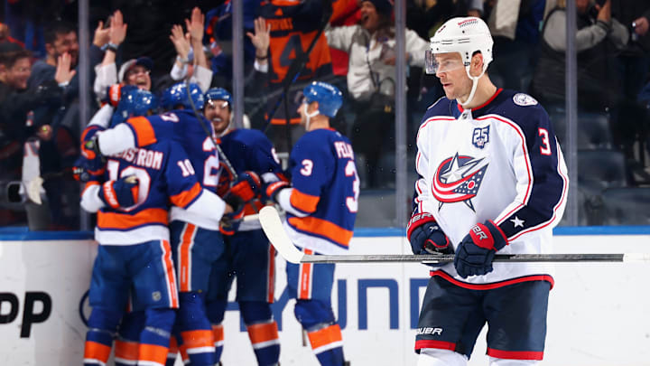 Blue Jackets center Charlie Coyle skates away as the Islanders celebrate their game winning goal. 