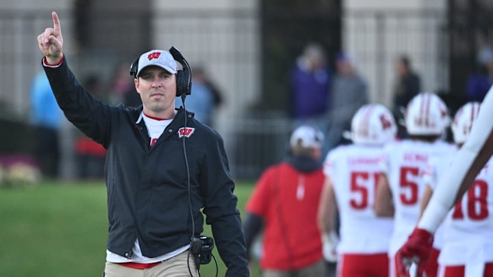 Oct 8, 2022; Evanston, Illinois, USA;  Wisconsin Badgers interim head coach Jim Leonhard singles for an extra point after a touchdown against the Northwestern Wildcats in the fourth quarter at Ryan Field. Mandatory Credit: Jamie Sabau-Imagn Images