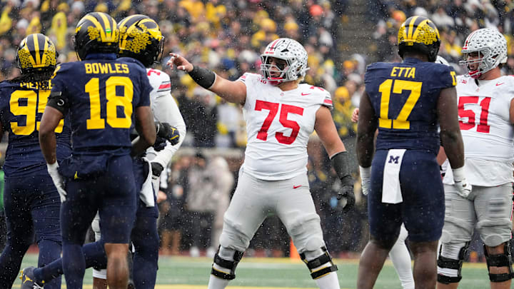 Ohio State Buckeyes offensive lineman Carson Hinzman (75) lines up during the NCAA football game against the Michigan Wolverines at Michigan Stadium in Ann Arbor, Mich. on Nov. 29, 2025. Ohio State won 27-9. Ohio State Buckeyes offensive lineman Carson Hinzman (75) lines up during the NCAA football game against the Michigan Wolverines at Michigan Stadium in Ann Arbor, Mich. on Nov. 29, 2025. Ohio State won 27-9.
