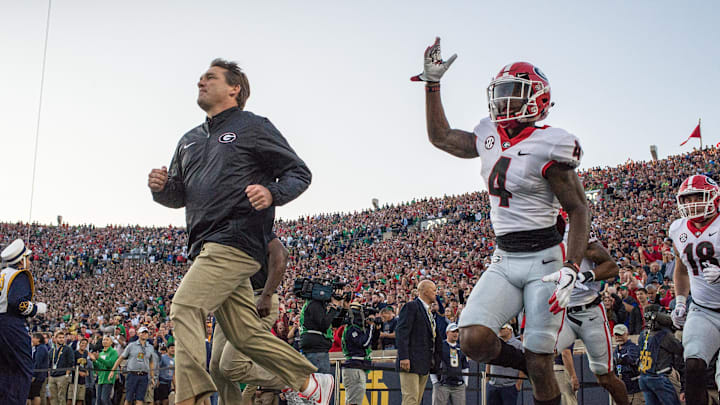 Sep 9, 2017; South Bend, IN, USA; Georgia Bulldogs head coach Kirby Smart and wide receiver Mecole Hardman (4) take the field for the game against the Notre Dame Fighting Irish at Notre Dame Stadium. Mandatory Credit: Matt Cashore-Imagn Images