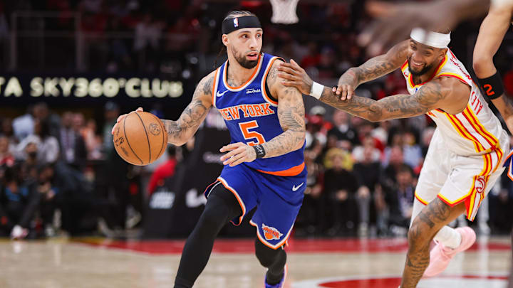 Knicks guard Jose Alvarado dribbles during a game.