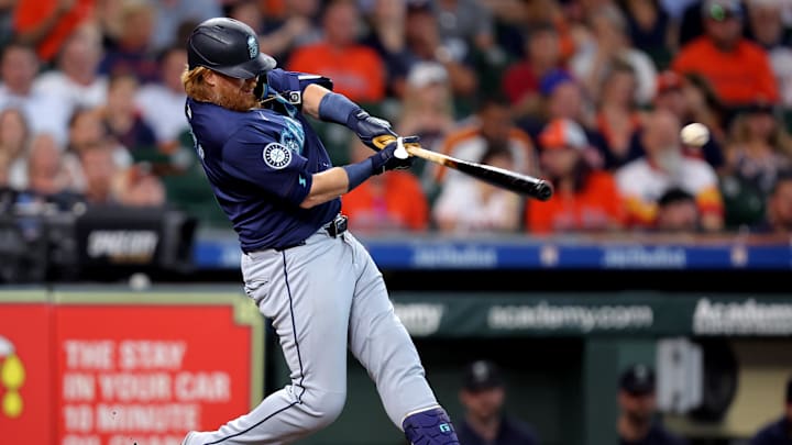 Sep 25, 2024; Houston, Texas, USA; Seattle Mariners first baseman Justin Turner (2) hits an RBI single to left field against the Houston Astros during the sixth inning at Minute Maid Park. 