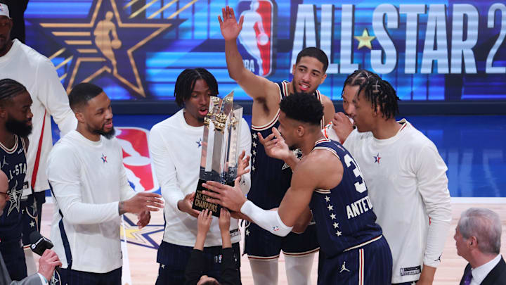 Guard Damian Lillard, guard Tyrese Maxey forward Giannis Antetokounmpo receive the trophy following their victory against the Western Conference All-Stars in the 73rd NBA All Star game