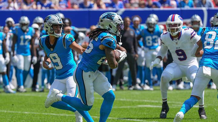Carolina Panthers quarterback Bryce Young (9) hands the ball off to Carolina Panthers running back Jonathon Brooks 