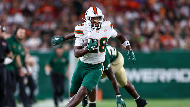 Sep 21, 2024; Tampa, Florida, USA;  Miami Hurricanes running back Ajay Allen (28) runs with the ball against the South Florida Bulls in the third quarter at Raymond James Stadium. Mandatory Credit: Nathan Ray Seebeck-Imagn Images