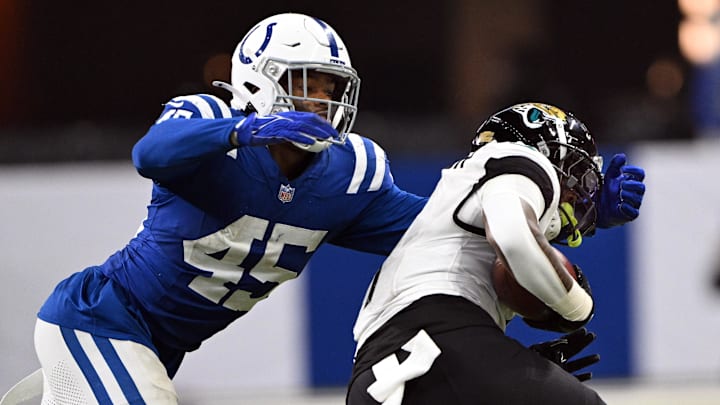 Jan 5, 2025; Indianapolis, Indiana, USA; Indianapolis Colts linebacker E.J. Speed (45) tackles Jacksonville Jaguars running back Travis Etienne Jr. (1) during the second half at Lucas Oil Stadium. Mandatory Credit: Marc Lebryk-Imagn Images