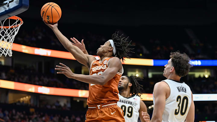 Texas guard Tre Johnson (20) drives past Vanderbilt guard Chris Manon (30) and forward Devin McGlockton (99) during the first half at Bridgestone Arena in Nashville, Tenn., Wednesday, March 12, 2025. Texas guard Tre Johnson (20) drives past Vanderbilt guard Chris Manon (30) and forward Devin McGlockton (99) during the first half at Bridgestone Arena in Nashville, Tenn., Wednesday, March 12, 2025.