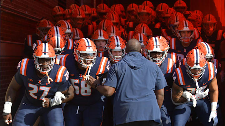 Oct 12, 2024; Champaign, Illinois, USA; Illinois fighting Illini players take the field before a game against the Purdue Boilermakers at Memorial Stadium. Mandatory Credit: Ron Johnson-Imagn Images Oct 12, 2024; Champaign, Illinois, USA; Illinois fighting Illini players take the field before a game against the Purdue Boilermakers at Memorial Stadium. Mandatory Credit: Ron Johnson-Imagn Images