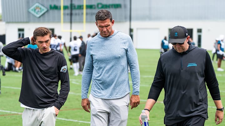 Jacksonville Jaguars general manager James Gladstone, left, Jacksonville Jaguars is executive vice president of football operations Tony Boselli, center and Jacksonville Jaguars head coach Liam Coen, right, all talk on the field after the Jacksonville Jaguars’ mandatory minicamp Tuesday June 10, 2025 at the Miller Electric Center in Jacksonville, Fla. [Doug Engle/Florida Times-Union]