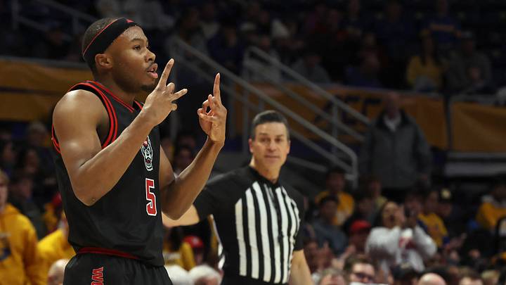Jan 24, 2026; Pittsburgh, Pennsylvania, USA;  NC State Wolfpack guard Tre Holloman (5) reacts after making a three point basket against the Pittsburgh Panthers during the first half at the Petersen Events Center. Mandatory Credit: Charles LeClaire-Imagn Images