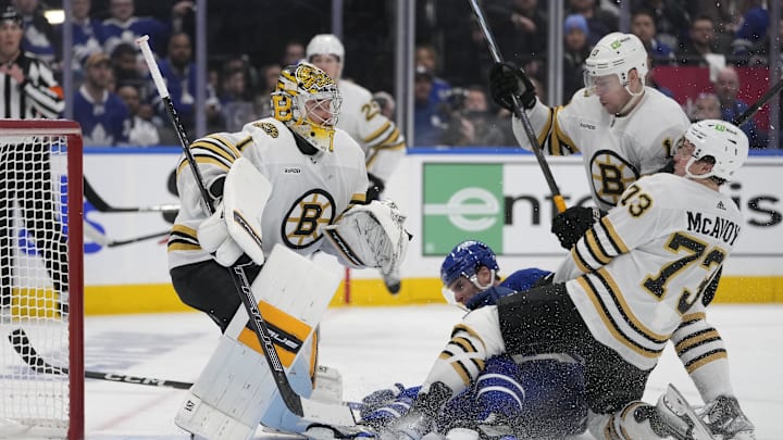 Apr 24, 2024; Toronto, Ontario, CAN; Boston Bruins goaltender Jeremy Swayman (1) looks for the puck as defenseman Charlie McAvoy (73) and forward Charlie Coyle (13) take Toronto Maple Leafs forward John Tavares (91) into the net during the third period of game three of the first round of the 2024 Stanley Cup Playoffs at Scotiabank Arena. Mandatory Credit: John E. Sokolowski-USA TODAY Sports