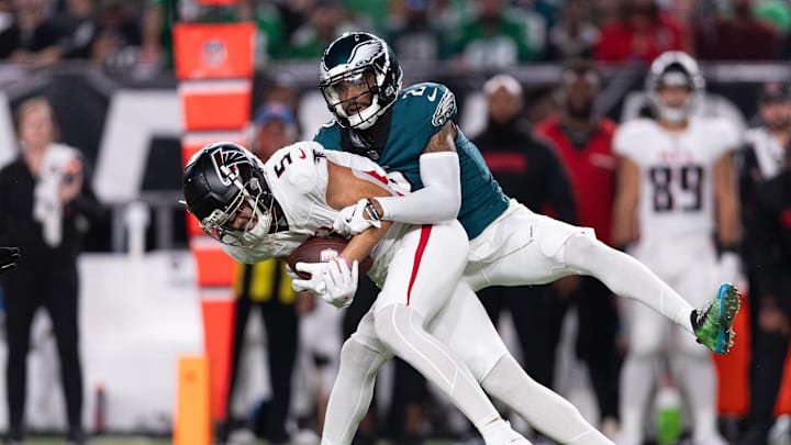 Sep 16, 2024; Philadelphia, Pennsylvania, USA; Atlanta Falcons wide receiver Drake London (5) is tackled by Philadelphia Eagles cornerback Darius Slay Jr. (2) after a catch during the first quarter at Lincoln Financial Field. Mandatory Credit: Bill Streicher-Imagn Images