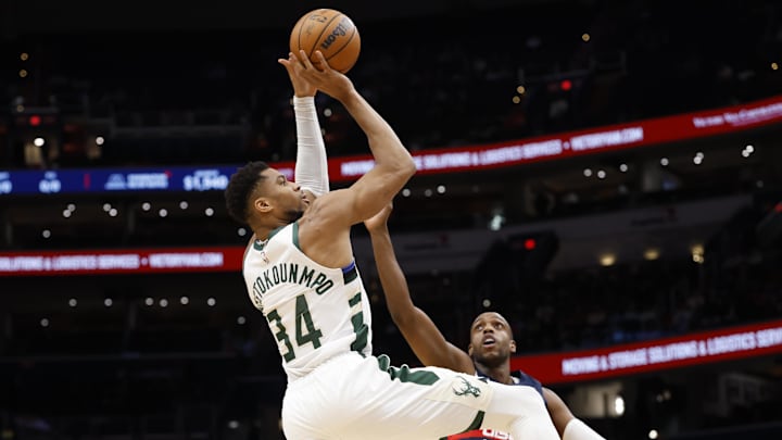 Dec 1, 2025; Washington, District of Columbia, USA; Milwaukee Bucks forward Giannis Antetokounmpo (34) shoots the ball over Washington Wizards forward Khris Middleton (22) in the first quarter at Capital One Arena. Mandatory Credit: Geoff Burke-Imagn Images