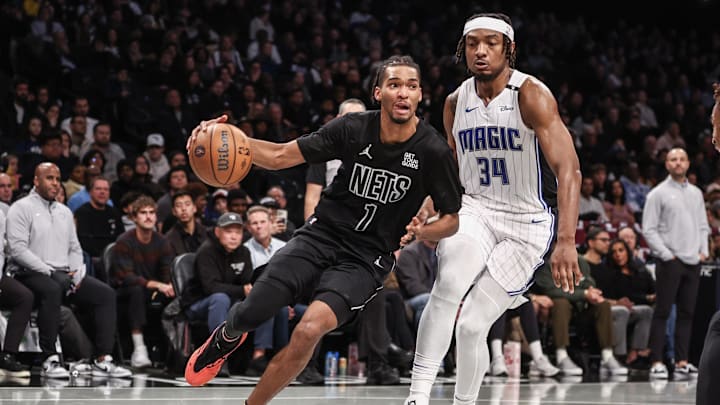 Nov 29, 2024; Brooklyn, New York, USA;  Brooklyn Nets forward Ziaire Williams (1) drives past Orlando Magic center Wendell Carter Jr. (34) in the second quarter at Barclays Center. Mandatory Credit: Wendell Cruz-Imagn Images