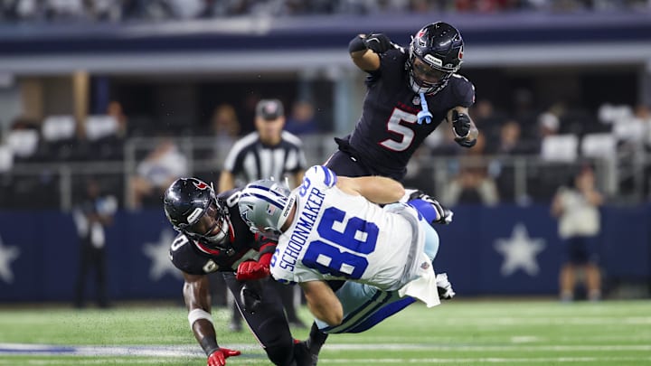 Nov 18, 2024; Arlington, Texas, USA; Houston Texans linebacker Azeez Al-Shaair (0) and Houston Texans safety Jalen Pitre (5) tackle Dallas Cowboys tight end Luke Schoonmaker (86) during the second half at AT&T Stadium. Mandatory Credit: Kevin Jairaj-Imagn Images Nov 18, 2024; Arlington, Texas, USA; Houston Texans linebacker Azeez Al-Shaair (0) and Houston Texans safety Jalen Pitre (5) tackle Dallas Cowboys tight end Luke Schoonmaker (86) during the second half at AT&T Stadium. Mandatory Credit: Kevin Jairaj-Imagn Images