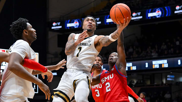 Dec 3, 2025; Nashville, Tennessee, USA;  Vanderbilt Commodores guard Frankie Collins (1) lays the ball in  over Southern Methodist University Mustangs guard Boopie Miller (2) during the first half at Memorial Gymnasium. Mandatory Credit: Steve Roberts-Imagn Images