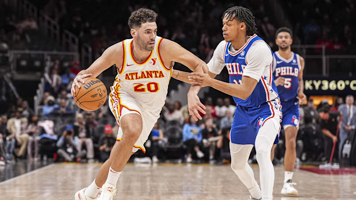 Mar 10, 2025; Atlanta, Georgia, USA; Atlanta Hawks forward Georges Niang (20) dribbles against Philadelphia 76ers guard Jeff Dowtin Jr. (11) during the second half at State Farm Arena. Mandatory Credit: Dale Zanine-Imagn Images