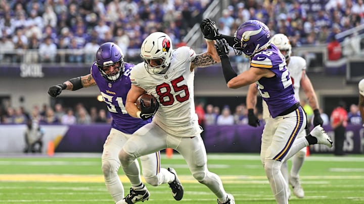 Dec 1, 2024; Minneapolis, Minnesota, USA; Arizona Cardinals tight end Trey McBride (85) fights off the tackle of Minnesota Vikings safety Harrison Smith (22) and linebacker Blake Cashman (51) during the second quarter at U.S. Bank Stadium. Mandatory Credit: Jeffrey Becker-Imagn Images
