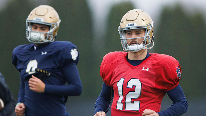 Notre Dame quarterback CJ Carr (12) runs to a drill during a Notre Dame football practice at Irish Athletic Center on Monday, Dec. 16, 2024, in South Bend.