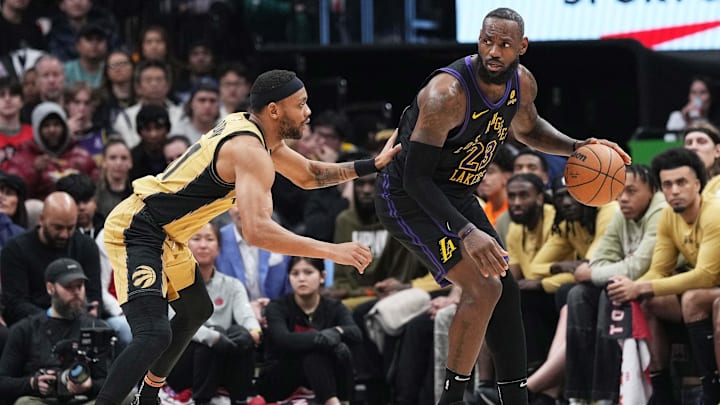 Apr 2, 2024; Toronto, Ontario, CAN; Los Angeles Lakers forward LeBron James (23) controls the ball as Toronto Raptors forward Bruce Brown (11) tries to defend during the third quarter at Scotiabank Arena. Mandatory Credit: Nick Turchiaro-Imagn Images