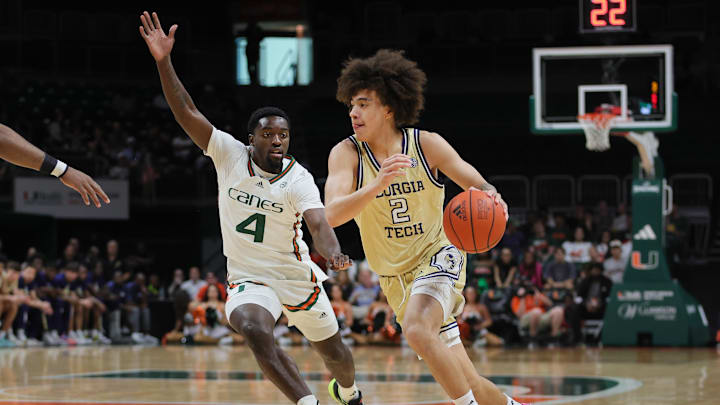 Feb 24, 2024; Coral Gables, Florida, USA; Georgia Tech Yellow Jackets guard Naithan George (2) drives to the basket past Miami Hurricanes guard Bensley Joseph (4) during the first half at Watsco Center. Mandatory Credit: Sam Navarro-Imagn Images