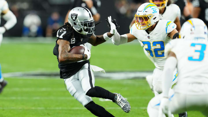 Dec 14, 2023; Paradise, Nevada, USA; Las Vegas Raiders wide receiver Davante Adams (17) runs against Los Angeles Chargers safety Alohi Gilman (32) in the first quarter at Allegiant Stadium. Mandatory Credit: Stephen R. Sylvanie-USA TODAY Sports