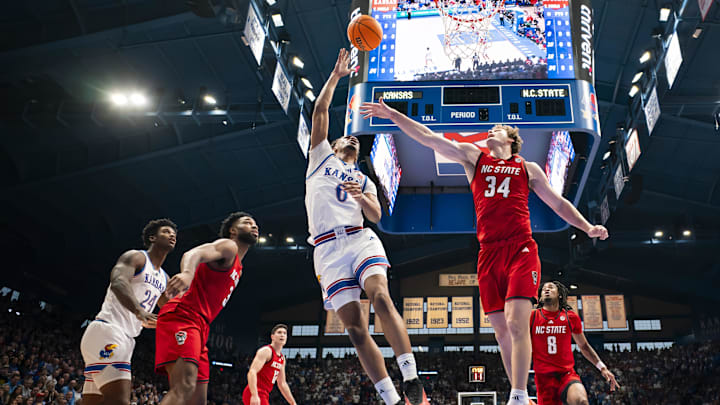 Dec 14, 2024; Lawrence, Kansas, USA; Kansas Jayhawks guard Rylan Griffen (6) shoots the ball against North Carolina State Wolfpack forward Ben Middlebrooks (34) during the first half at Allen Fieldhouse. Mandatory Credit: Jay Biggerstaff-Imagn Images Dec 14, 2024; Lawrence, Kansas, USA; Kansas Jayhawks guard Rylan Griffen (6) shoots the ball against North Carolina State Wolfpack forward Ben Middlebrooks (34) during the first half at Allen Fieldhouse. Mandatory Credit: Jay Biggerstaff-Imagn Images