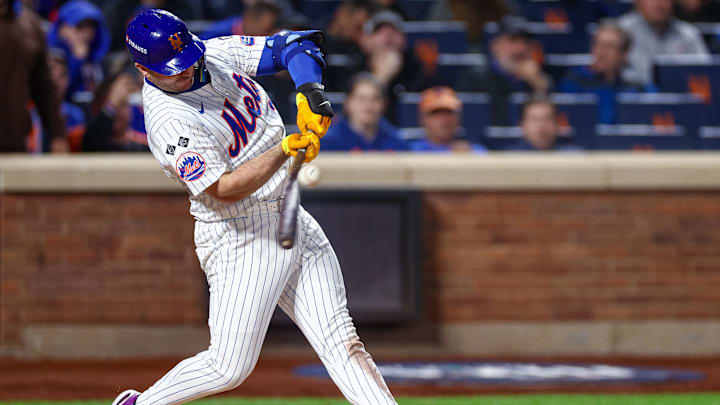 New York Mets first baseman Pete Alonso (20) singles during the eighth inning against the Los Angeles Dodgers during game five of the NLCS for the 2024 MLB playoffs at Citi Field. 